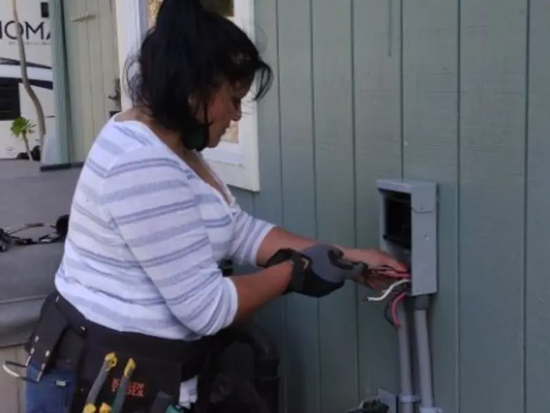 Licensed electrician wiring an exterior subpanel in Highlands